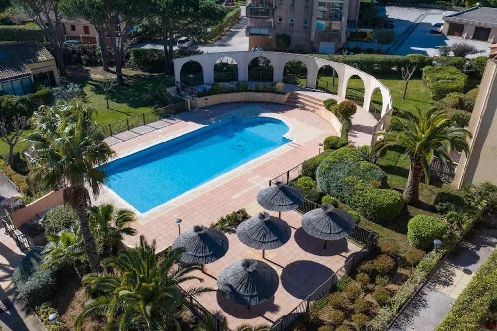 une vue aérienne d'une piscine avec des parasols dans l'établissement T3 Escale à Giens, à Hyères