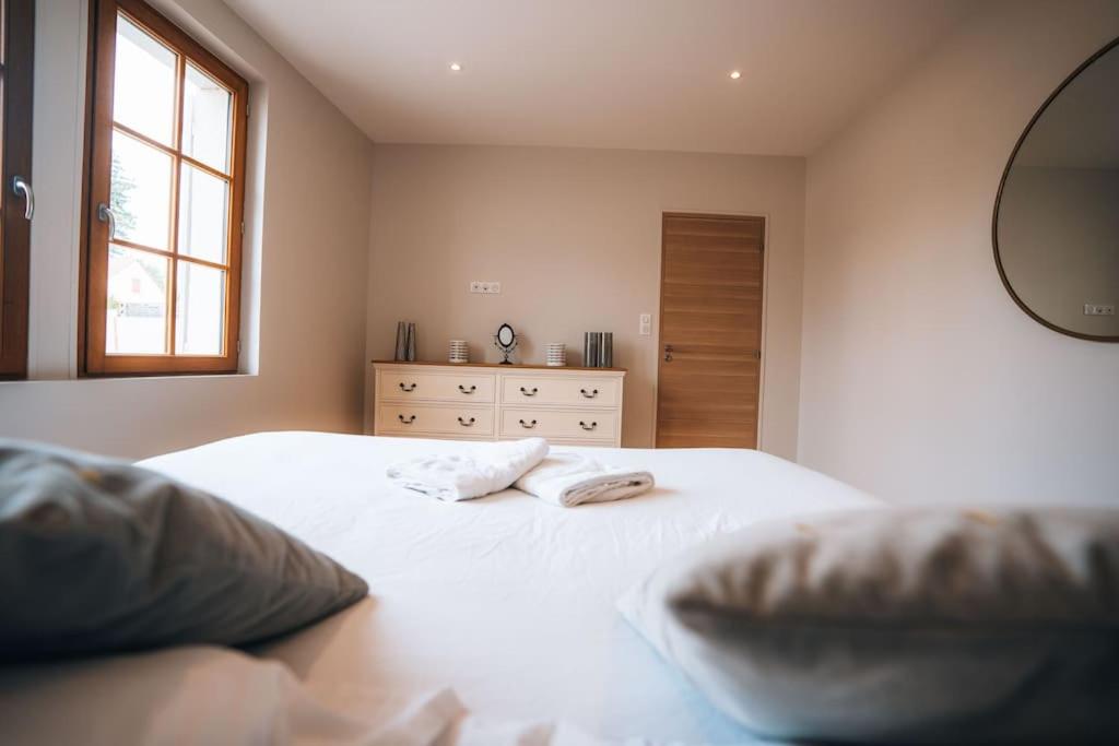 a bedroom with two white beds and a mirror at Le Gué • Élégance fonctionnelle • Parking simple in Saint-Maur