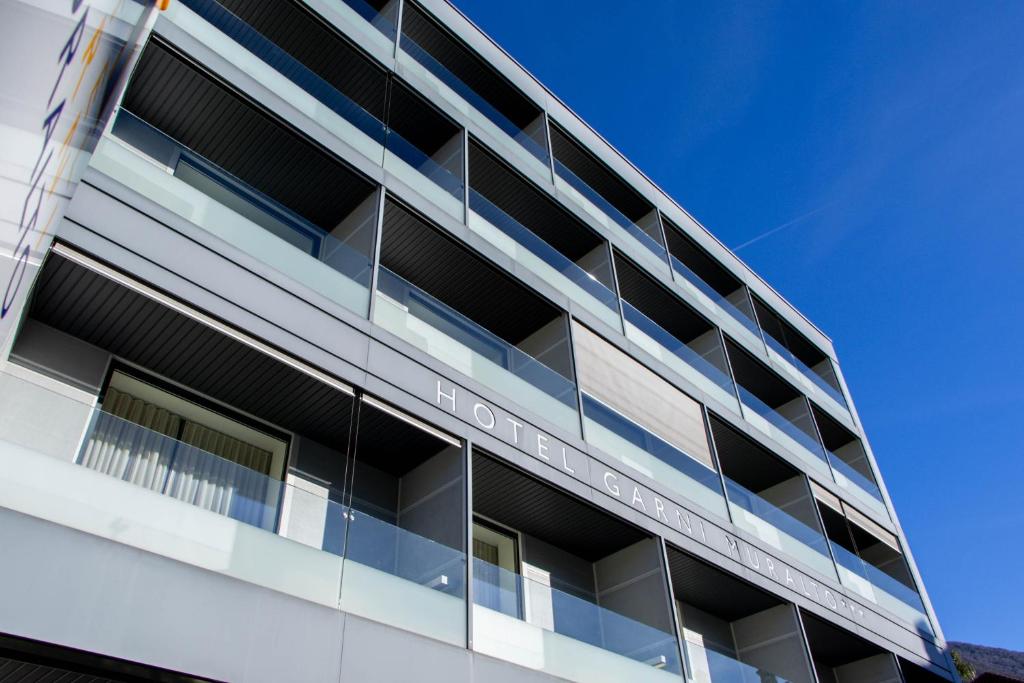 an office building with balconies on the side of it at Hotel Muralto Locarno in Locarno