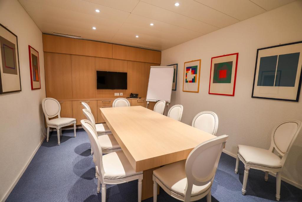 a conference room with a table and chairs at Hotel Muralto Locarno in Locarno