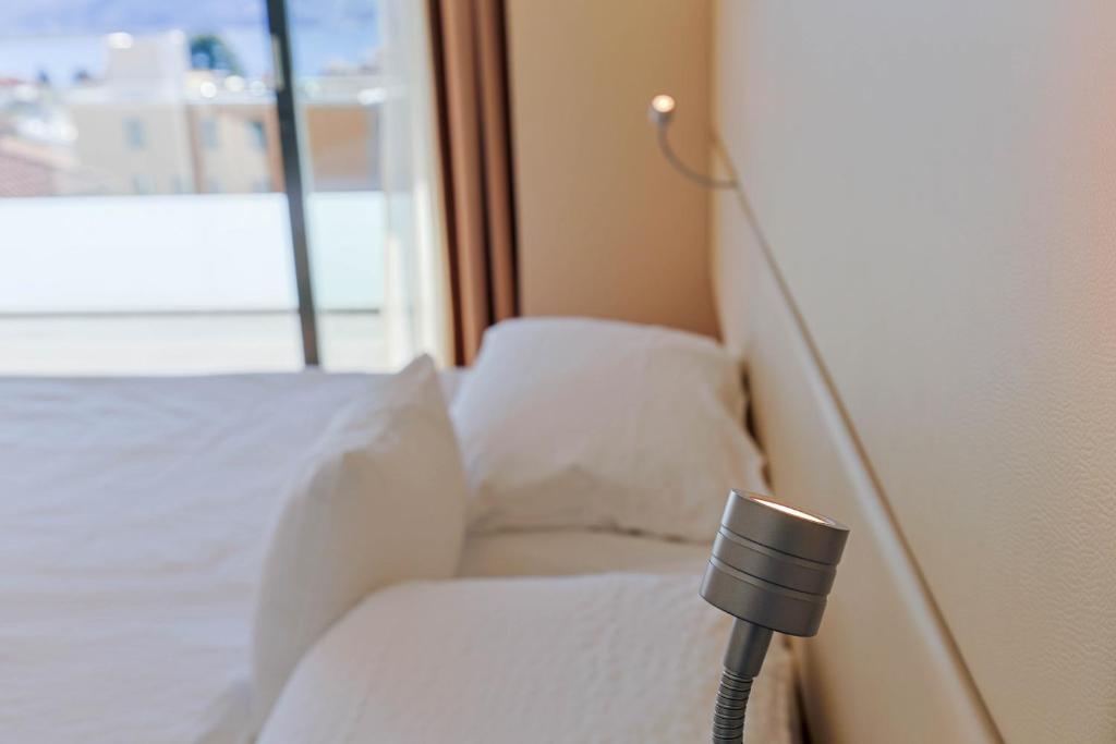 a room with a bed with a speaker on it at Hotel Muralto Locarno in Locarno