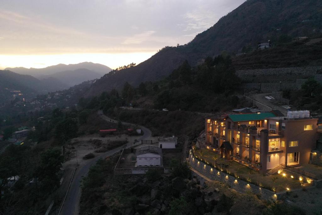 an aerial view of a building with lights in the mountains at Mountoria Retreat Bhimtal- by Leisure Hotels Group in Bhīm Tāl