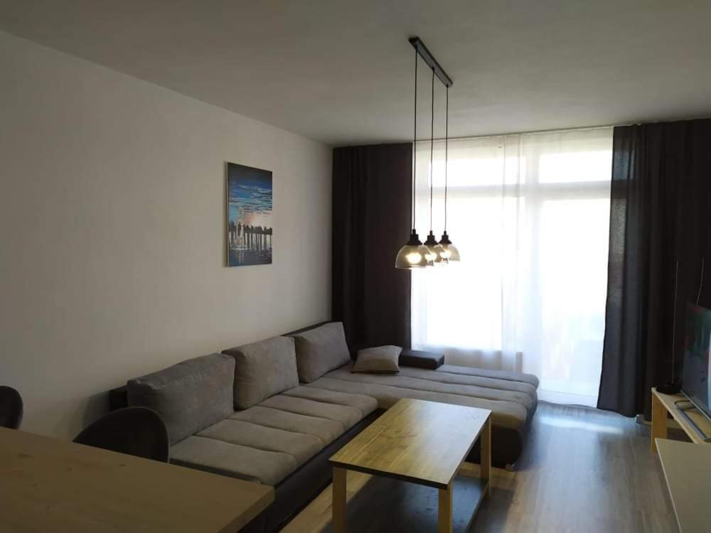 a living room with a couch and a table at Apartment 33 Mlynská Bašta in Košice