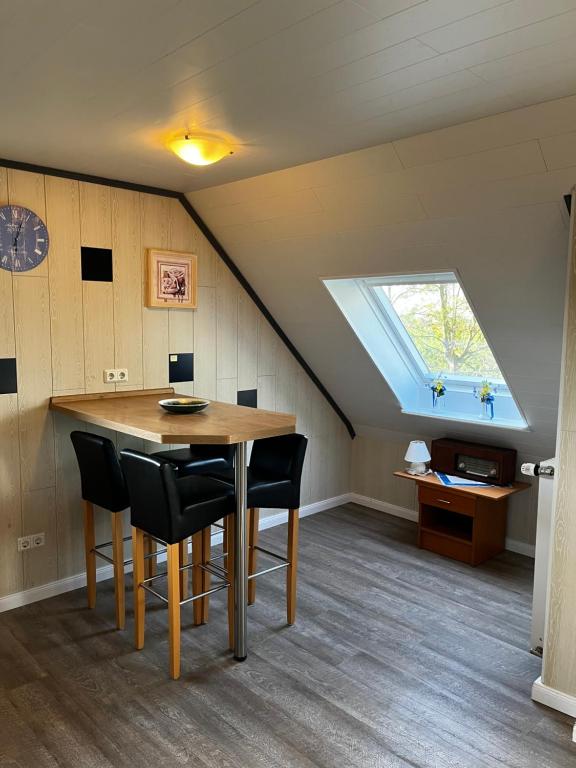 a dining room with a table and a skylight at Apartment Bakenweg für maximal 4 Personen in Norden