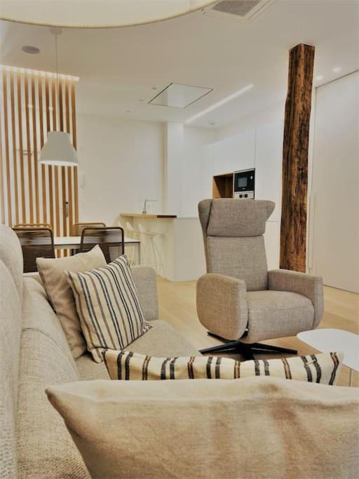 a living room with a couch and a chair at ATSEDEN apartment aire condicionado - Opción a parking - in San Sebastián