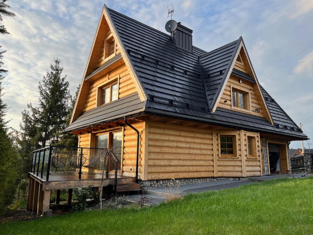 a house with a gambrel roof on top of it at Willa Gocówka & SPA in Bukowina Tatrzańska