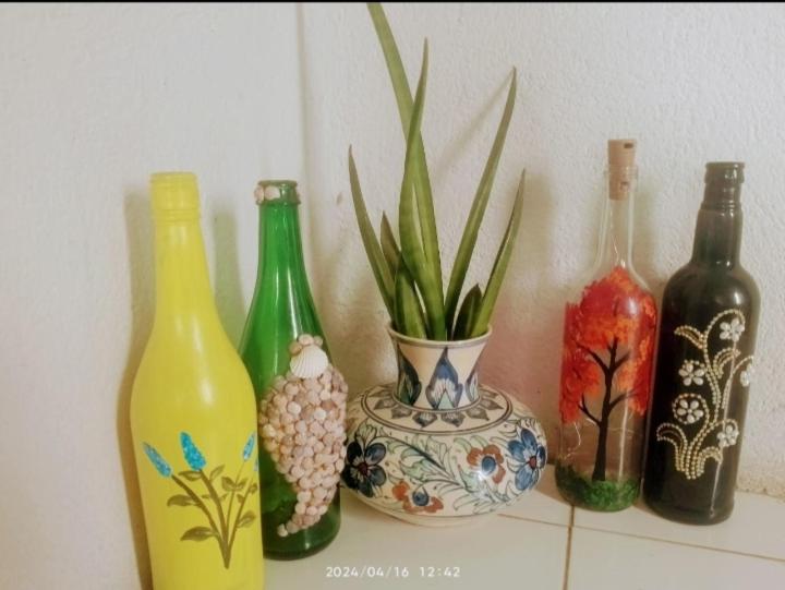 a group of different colored bottles sitting on a shelf at Traveler House in Dimāpur