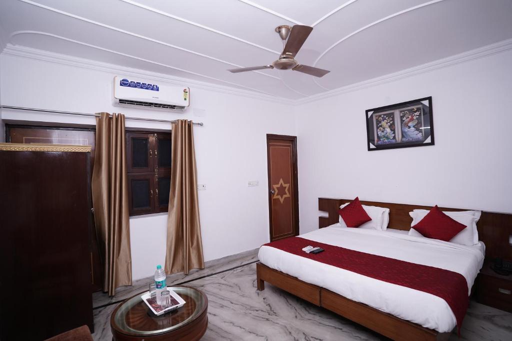 a bedroom with a bed and a ceiling fan at Hotel Lecston @Yashobhoomi Dwarka Sector - 25 metro station in New Delhi