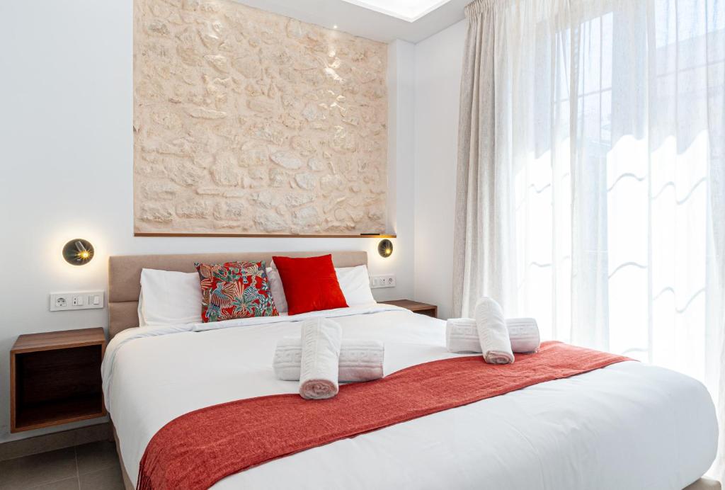 a bedroom with a large white bed with red pillows at Myflats Luxury Cathedral in Alicante