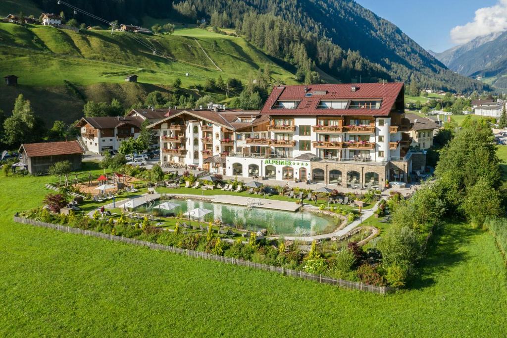 an aerial view of a resort with a swimming pool at Alpeiner - Nature Resort Tirol in Neustift im Stubaital