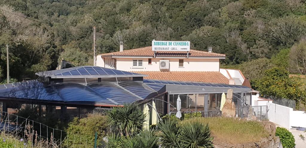 a house with a roof with solar panels on it at AUBERGE DE CANNEDDA in Sari Solenzara