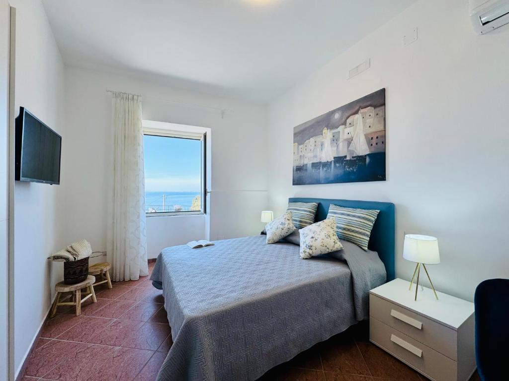 a bedroom with a bed and a large window at YourHome - Purtual House in Piano di Sorrento