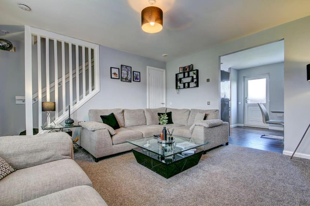 a living room with a couch and a glass table at Ardfin Road - Prestwick The Open in Prestwick