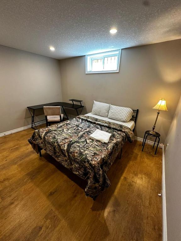 a bedroom with a bed and a table and a window at Budget Stay in Kitchener- Near Town Centre- Food, Shopping, Transit in Kitchener