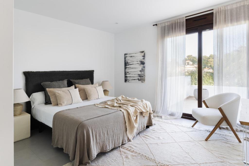 A bed or beds in a room at Villas Guzman - Artista