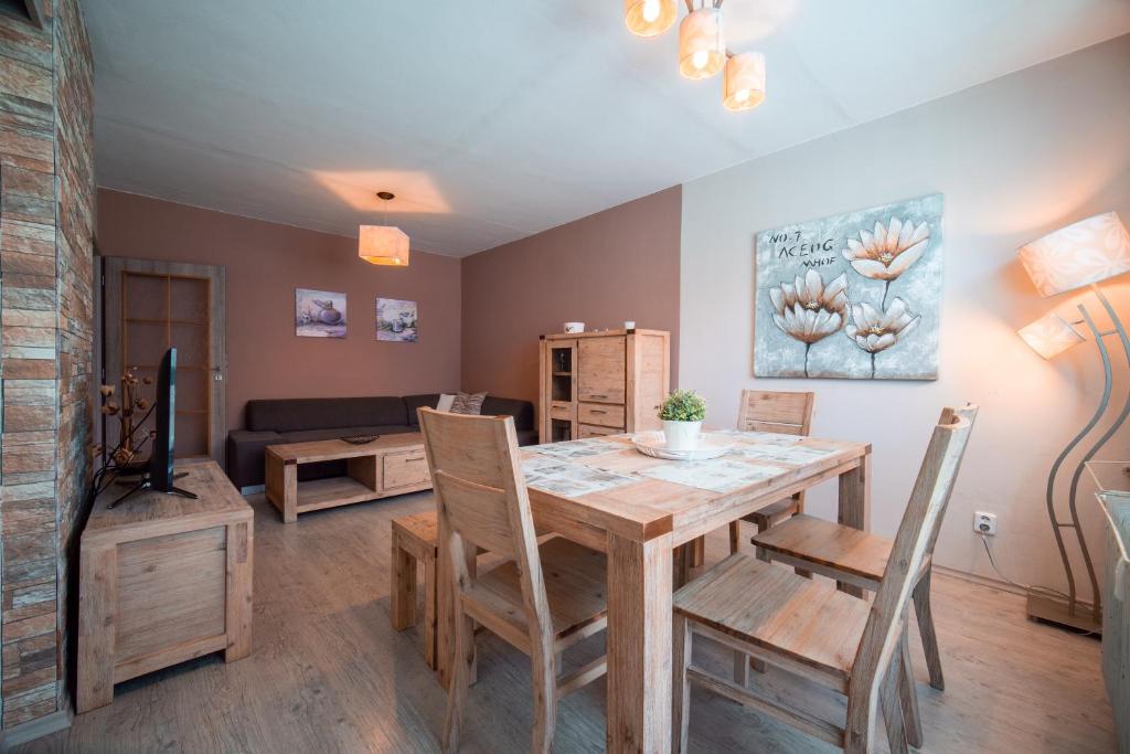 a living room with a wooden table and chairs at Apartmán Loučná nad Desnou in Loučná nad Desnou