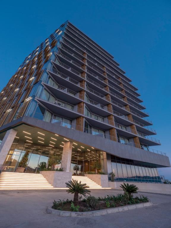a tall building with a lot of windows at Sea Star Budva in Budva