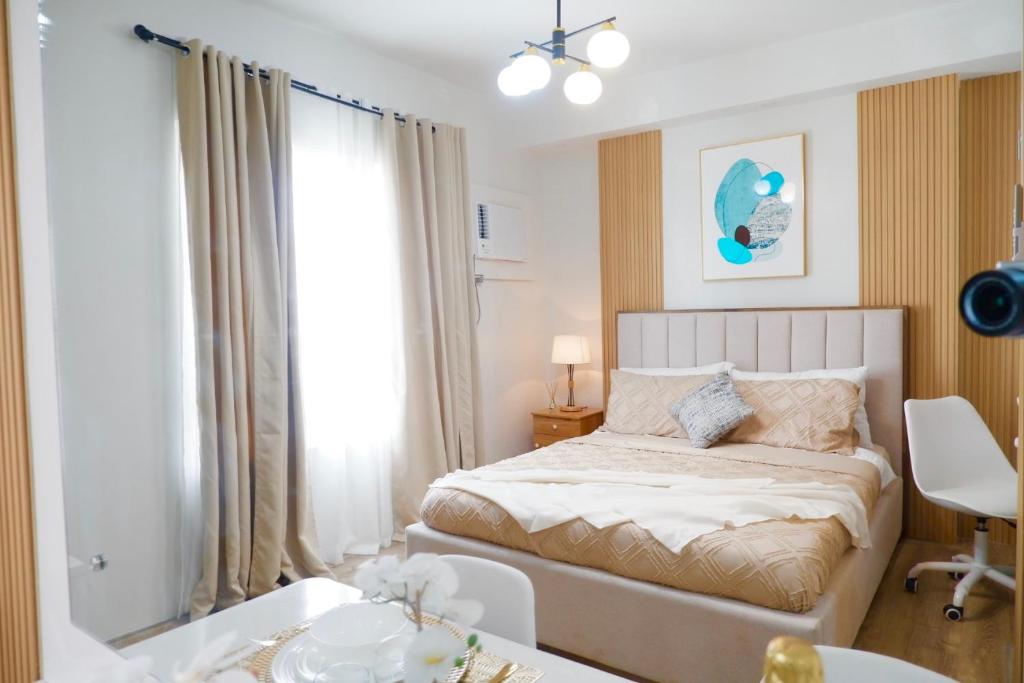 a small bedroom with a bed and a window at Ezren Suites Mesavirre Residences Unit922 in Bacolod
