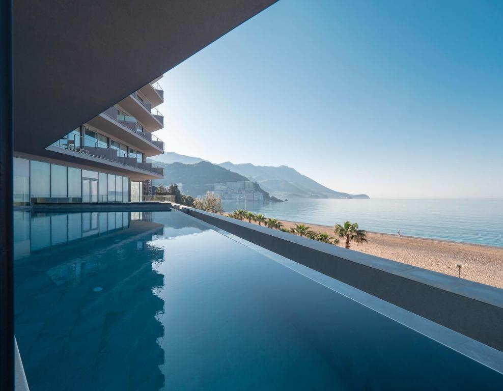 a swimming pool with a view of the ocean at Sea Star Budva in Budva