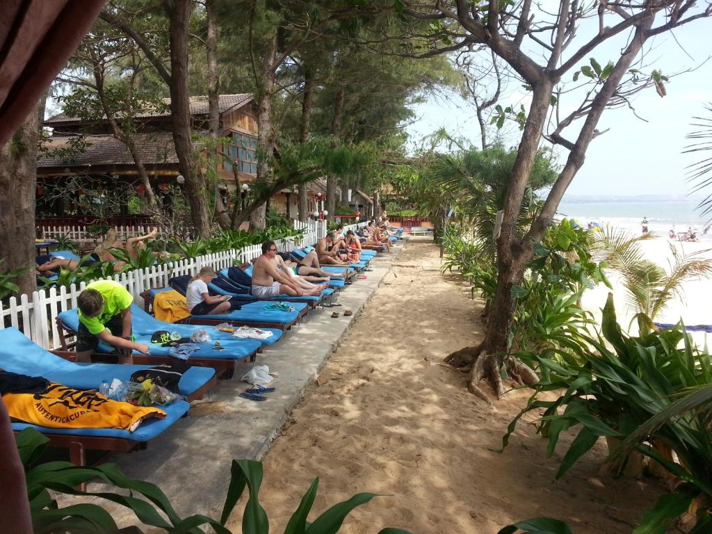 a group of people sitting on chairs on the beach at Vinh Suong Seaside Hotel and Resort in Mui Ne
