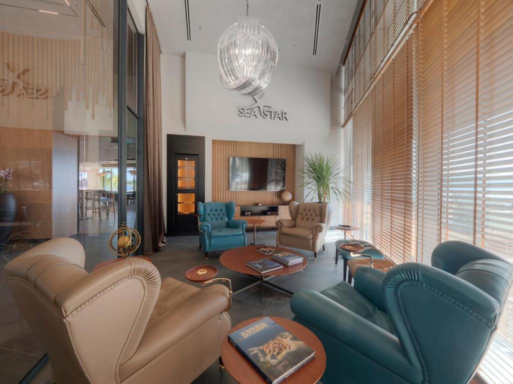 a lobby with couches and chairs in a room at Sea Star Budva in Budva