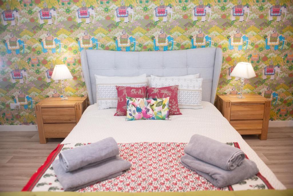 a bedroom with a white bed with pillows on it at Mill Cottage Garden Studio nr Melrose in Melrose