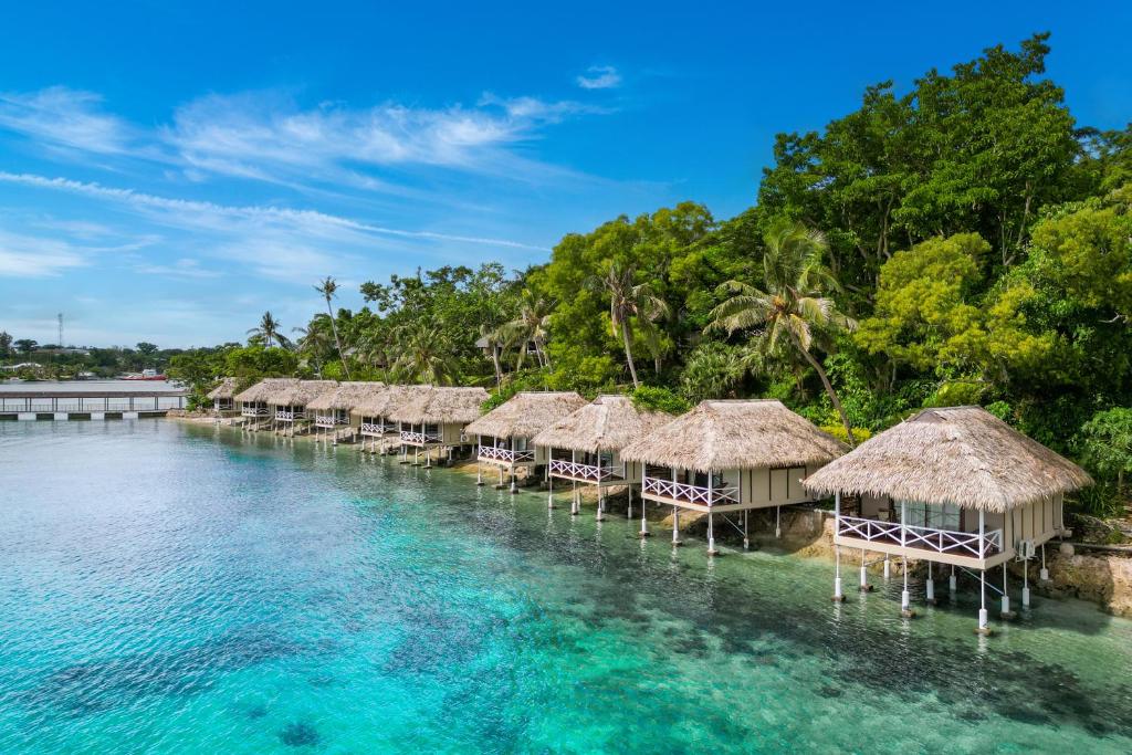 a row of overwater bungalows on the water at Iririki Island Resort & Spa in Port Vila