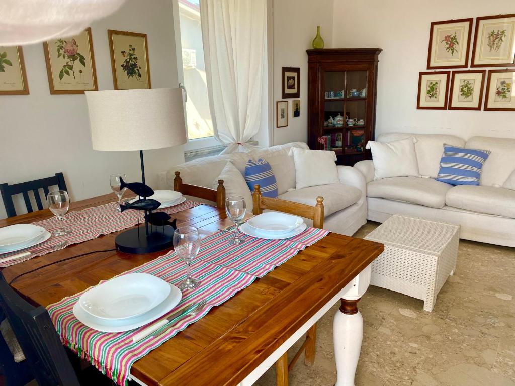 a living room with a table with plates on it at Family House in Santa Severa
