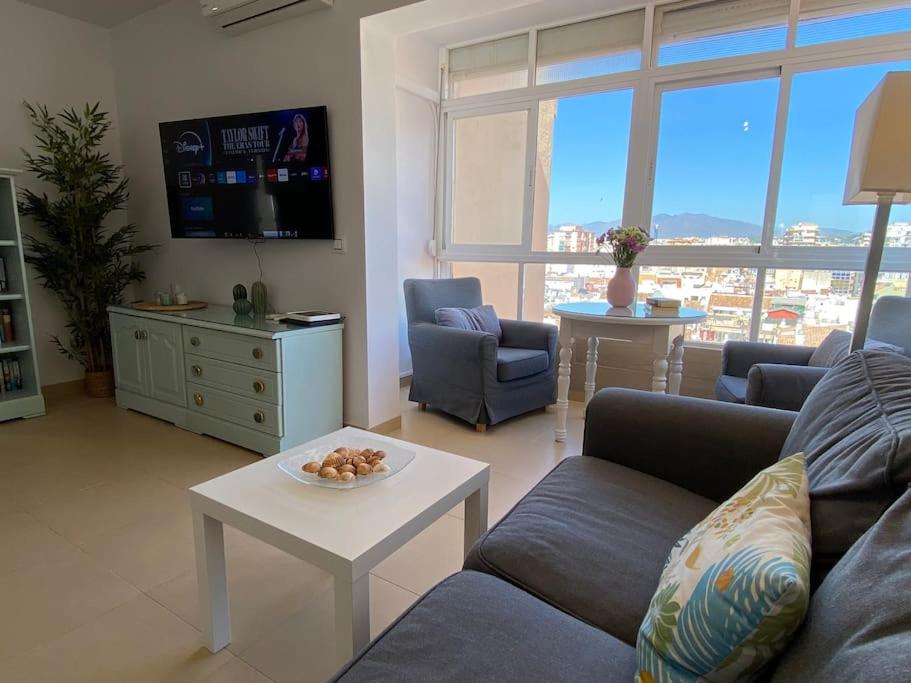 a living room with a couch and a table at City & Beach Top-Floor Apartment in Fuengirola
