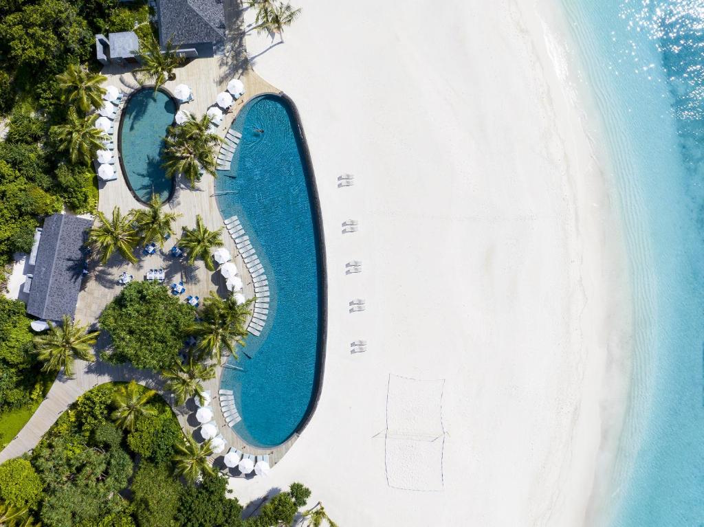 an overhead view of a swimming pool next to a beach at RAAYA By Atmosphere - Premium All Inclusive with Free Transfers in Raa Atoll