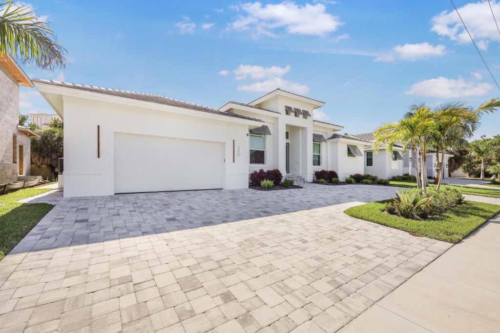 a white house with a large driveway at 280 West Flamingo Circle in Marco Island