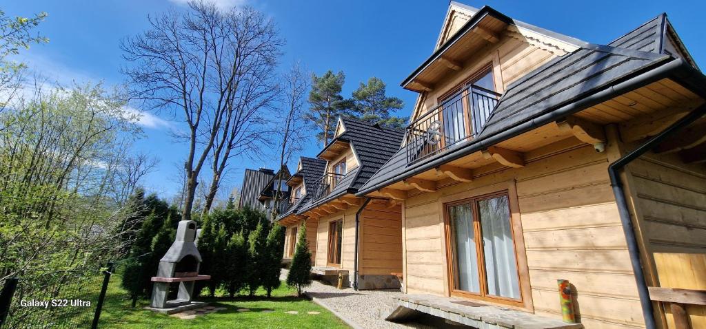 a wooden house with a roof on top of it at Sebahouse in Zakopane