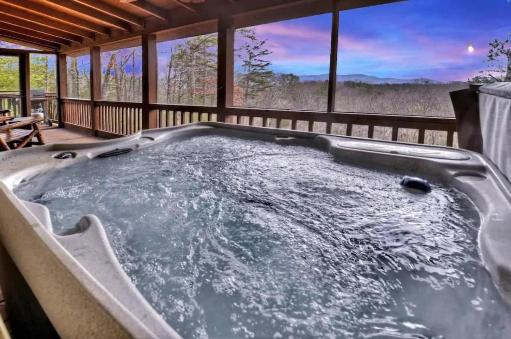 a hot tub on the deck of a cabin at Mountain Views Hot Tub FirePit Close to town in Blue Ridge