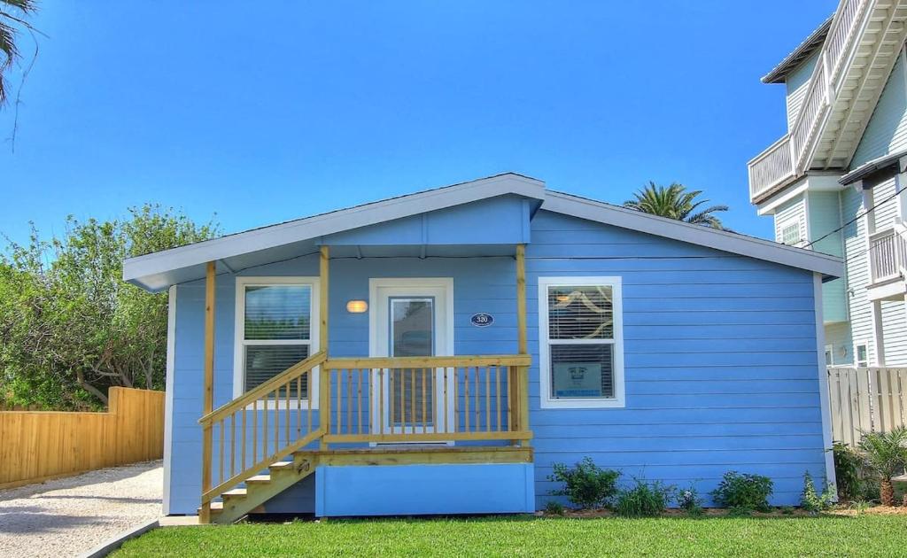 a blue tiny house with a deck at The Blue Pearl in Port Aransas