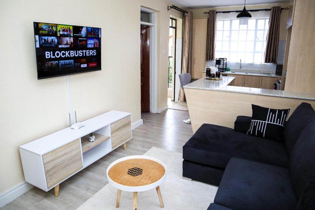 a living room with a couch and a table at Apartment in Nakuru in Nakuru