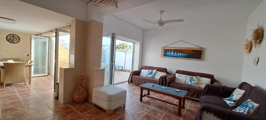 a living room with a couch and a table at Casa Isleta in La Manga del Mar Menor