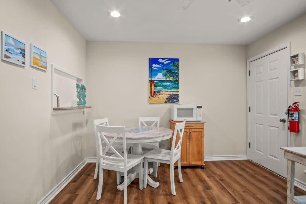 a kitchen with a table and chairs in a room at Fish Station Bike Rack BBQ Golf Cart Access in Port Aransas