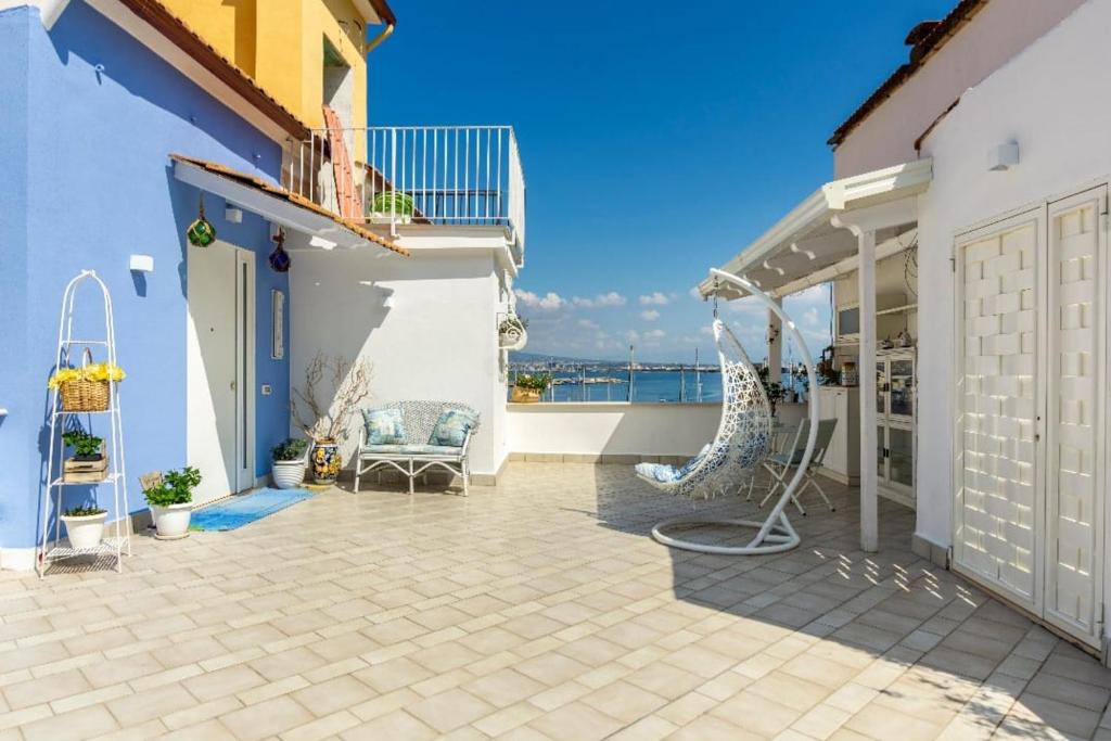 a patio with a view of the ocean at coralinehome in Castellammare di Stabia