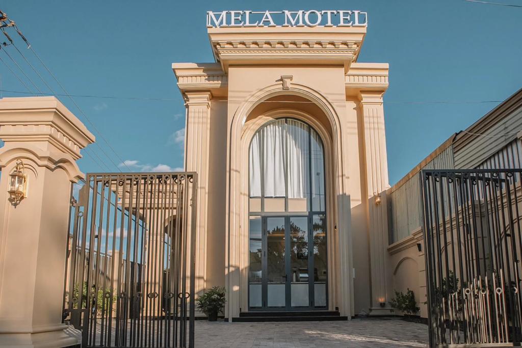 a building with an entrance to a meega motel at MELA HOTEL in Mỹ Thạch