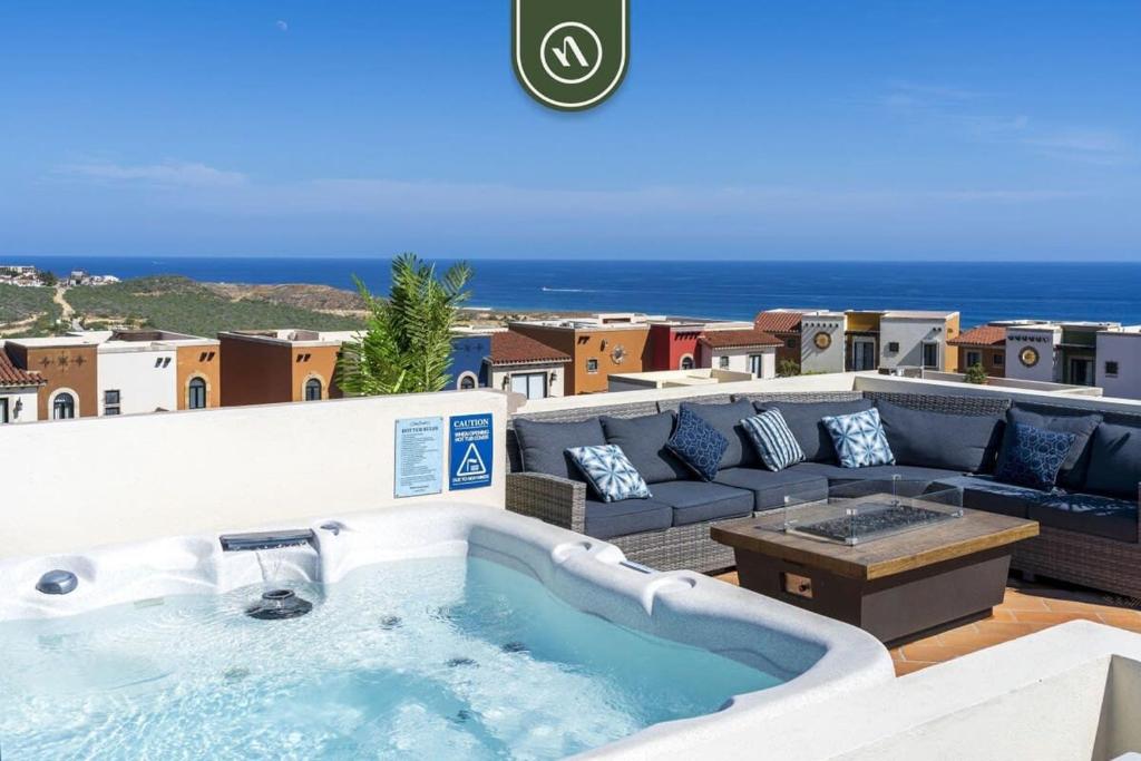 a hot tub on a balcony with a couch at Copala at Quivira 71 in Cabo San Lucas
