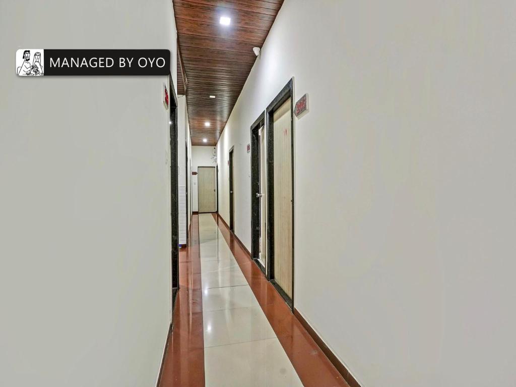 a hallway of a building with a sign on the wall at Super OYO Kailash Park Near Shivaji International Airport in Mumbai
