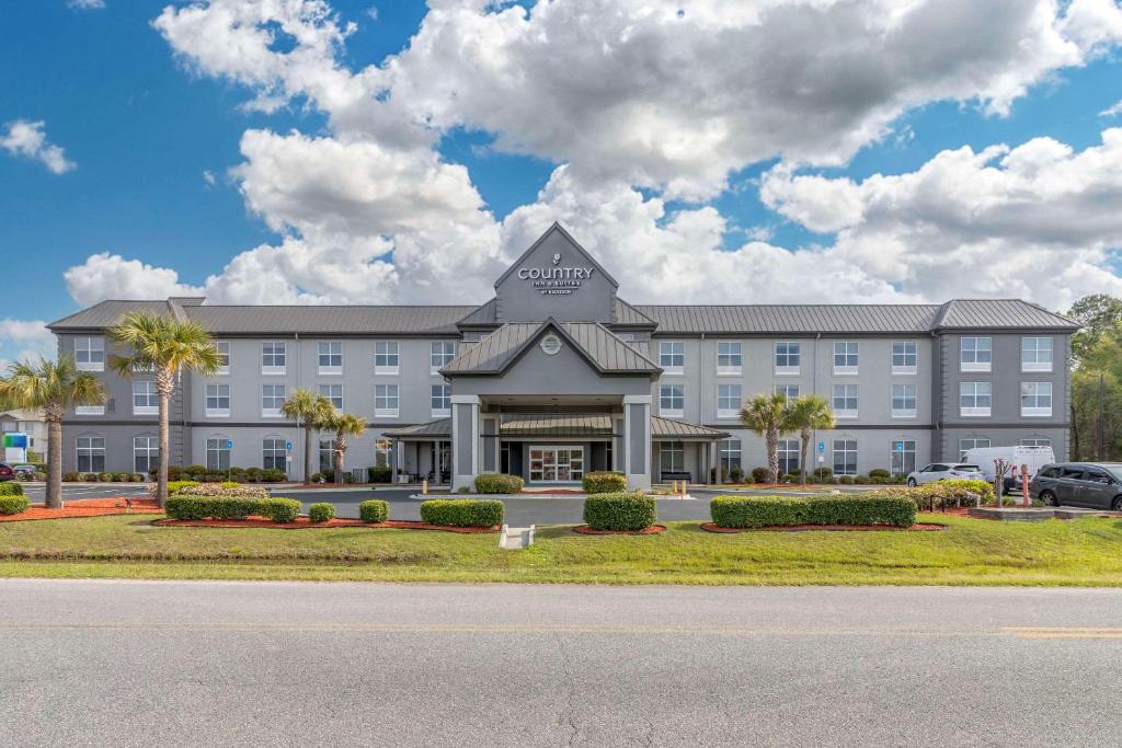 a large building with a sign on the front of it at Country Inn & Suites By Radisson, Savannah Airport, GA in Savannah