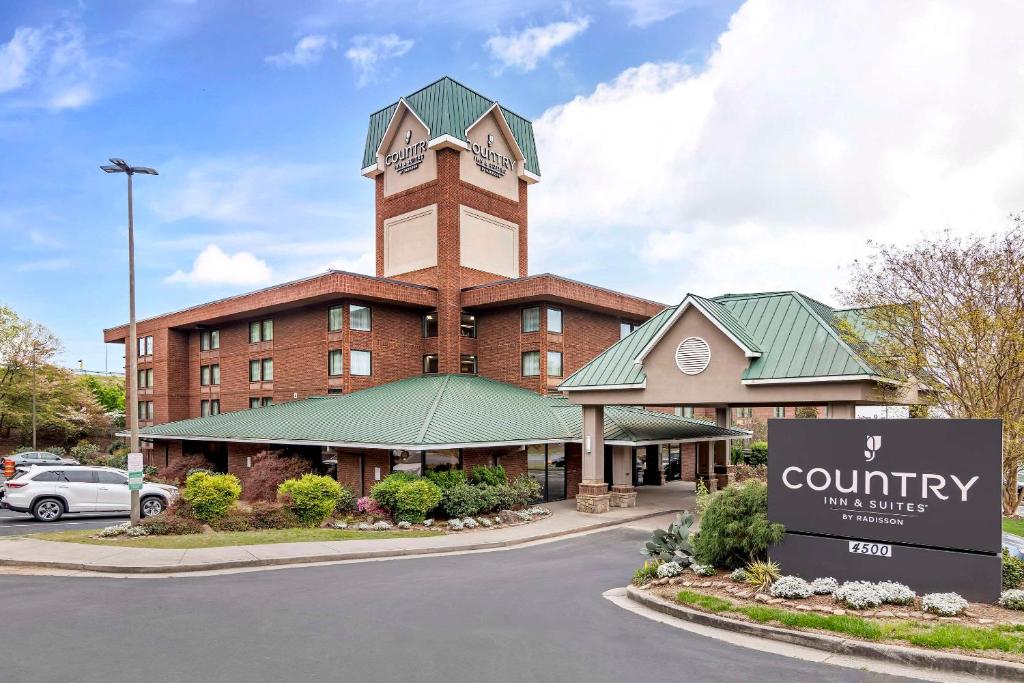 a building with a clock tower on top of it at Country Inn & Suites by Radisson, Atlanta Galleria-Ballpark, GA in Atlanta