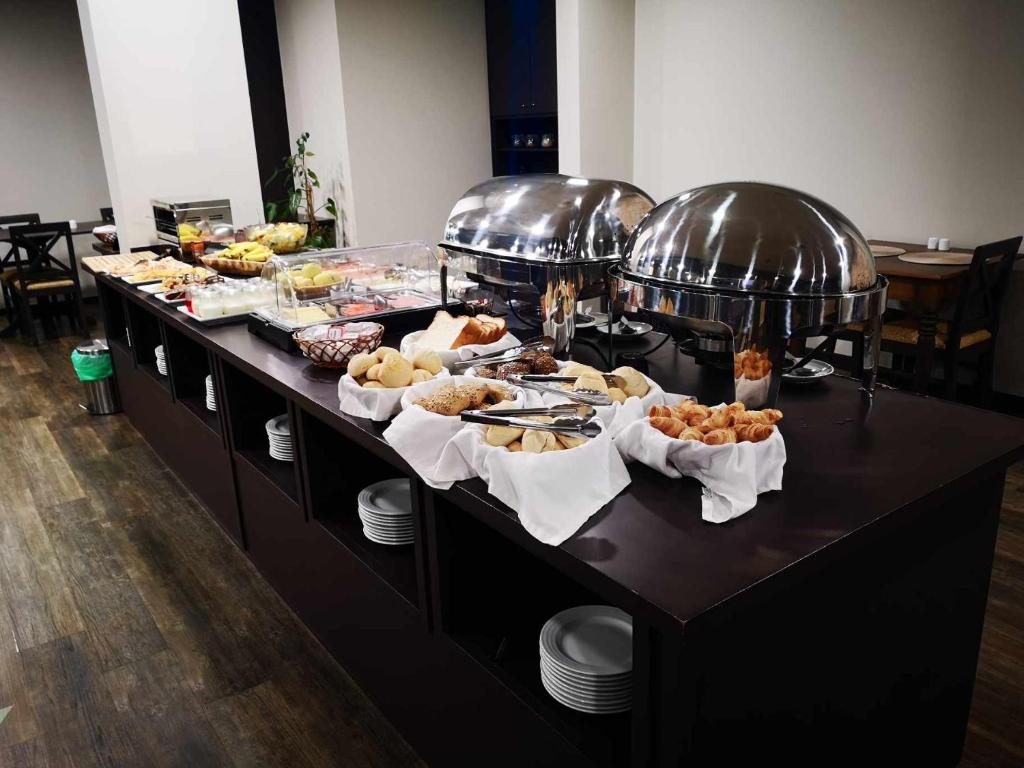 a buffet line with many different types of food at Hotel Euro Moniz in Porto Moniz