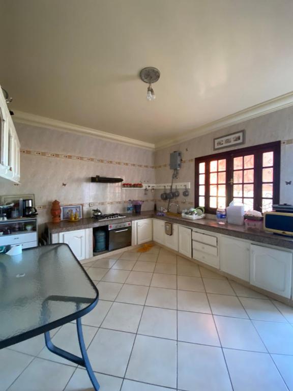 a large kitchen with a table in the middle of it at villa à souiriya kdima in Safi