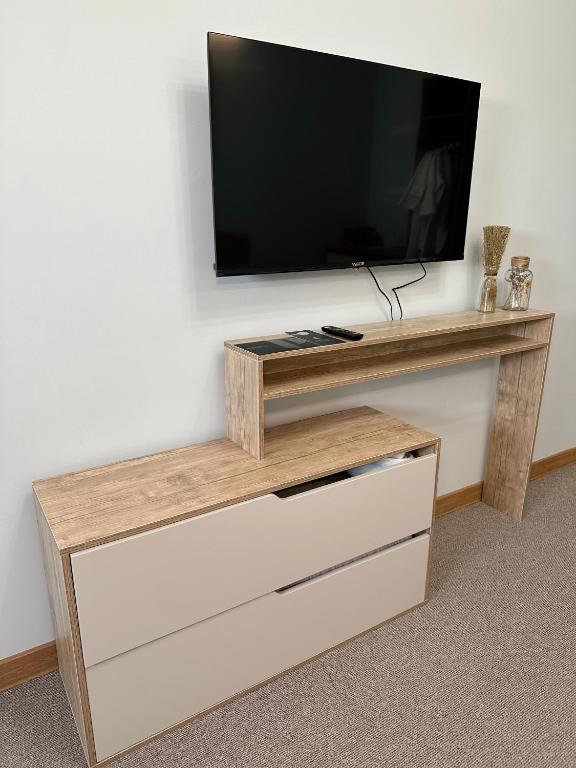 a entertainment center with a flat screen tv on a wall at PORT INN Hotel in Astana
