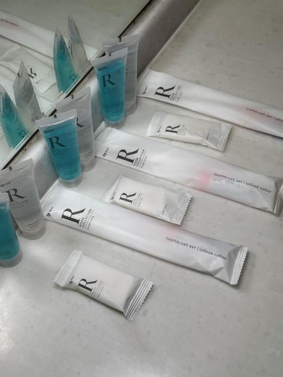 a group of white toothbrushes on a counter at PORT INN Hotel in Astana
