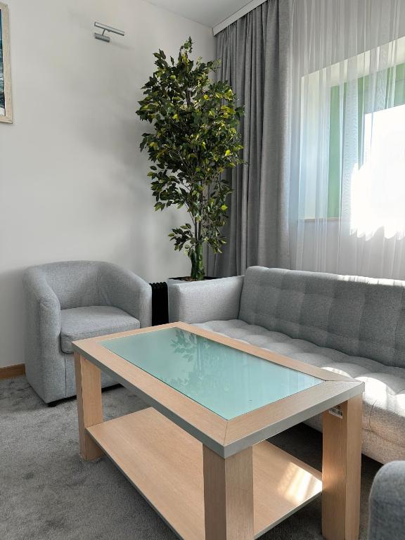 a living room with a couch and a coffee table at PORT INN Hotel in Astana