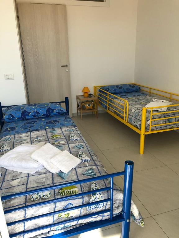Postel nebo postele na pokoji v ubytování Petali Rosa- Dimora Orizzonte vista mare