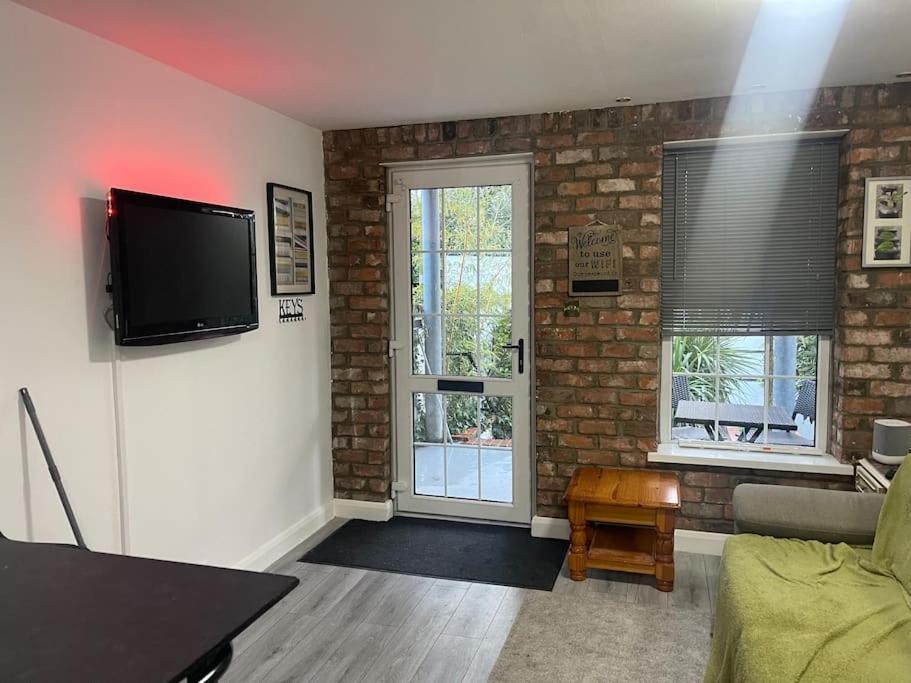 a living room with a flat screen tv on the wall at Bangor by the Sea in Bangor